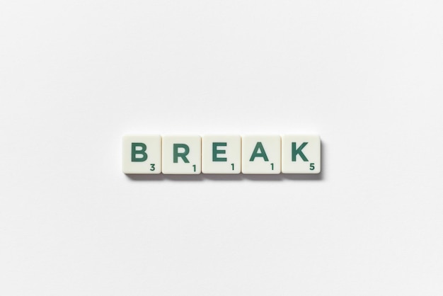 Break formed of scrabble blocks on white background