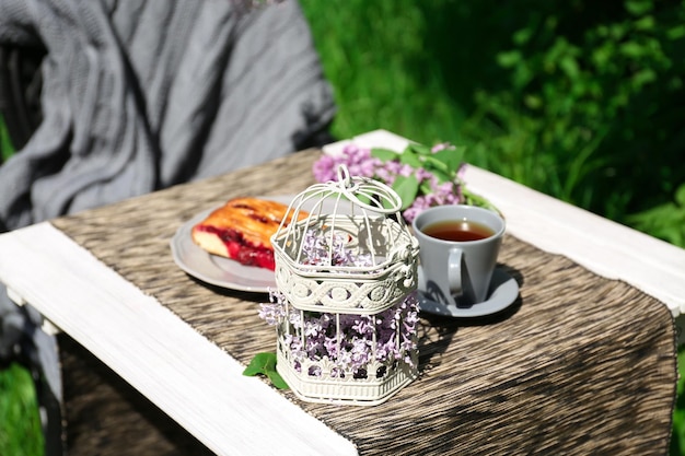 Breakfast in beautiful garden with lilac decoration