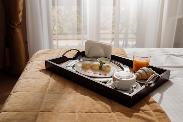 Breakfast in bed with cheesecake and juice in the hotel