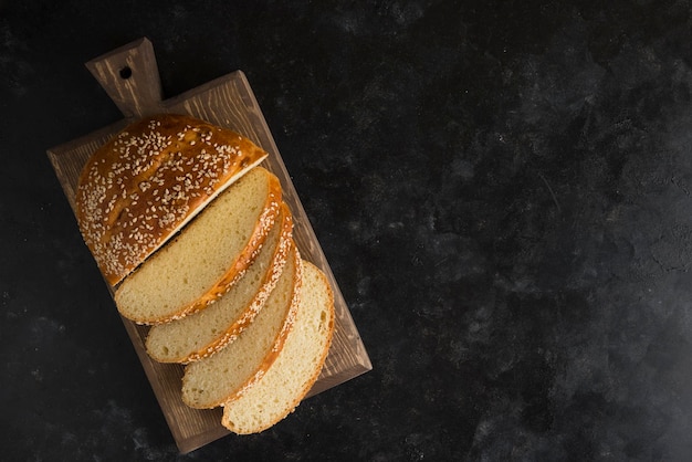 Breakfast bread on cutting board dark background