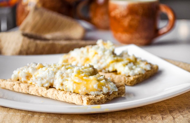 Breakfast of bread with cottage cheese and honey