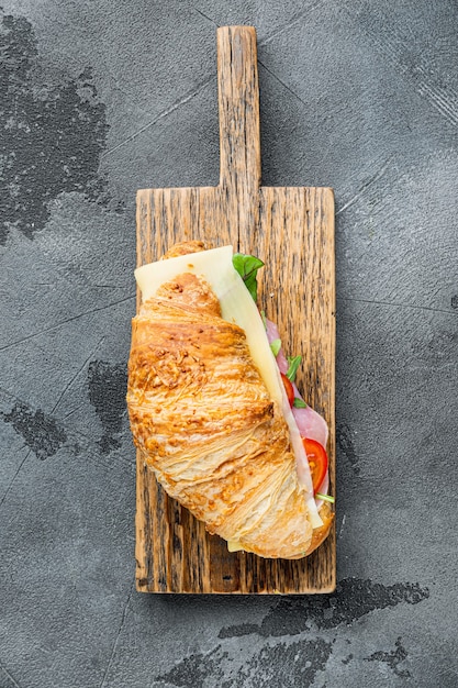 Breakfast, business lunch, sandwiches Croissant set, on gray stone background, top view flat lay