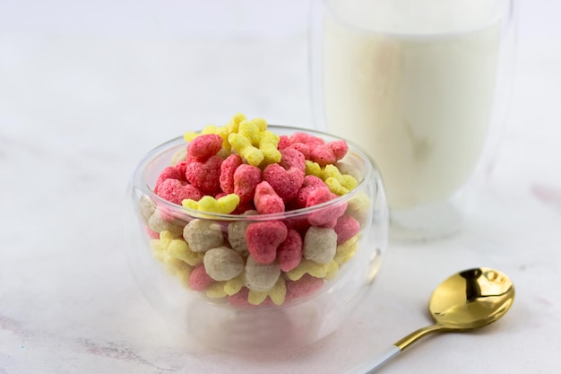 Breakfast cereal closeup Bowl of corn flakes on a white marble table