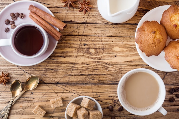 Breakfast and coffee, pastries, brown sugar and cinnamon with anise on wood