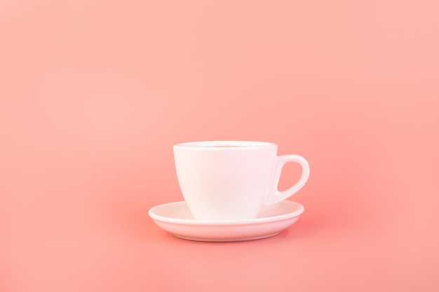 Breakfast and coffee theme white empty ceramic coffee cup on a pink background advertising coffee