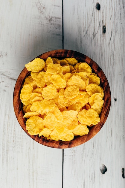 Breakfast cornflakes in a wooden bowl