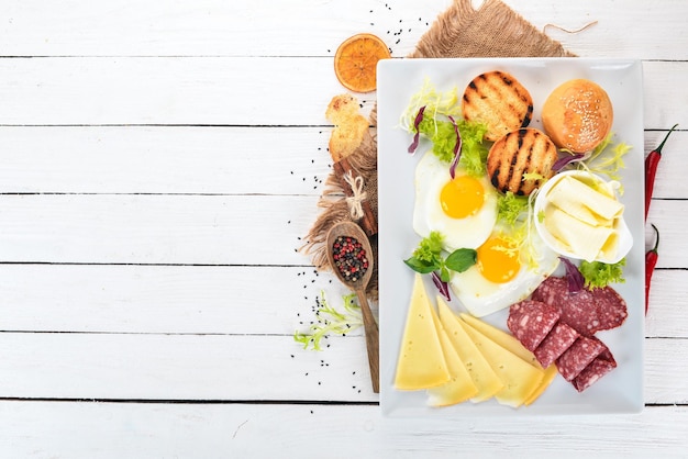 Breakfast Eggs with bacon and tomatoes toast bread Top view On a wooden background Copy space