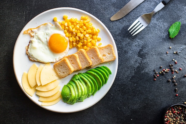 Breakfast fried egg bread toast vegetables corn cheese and more on the table serving healthy meal snack