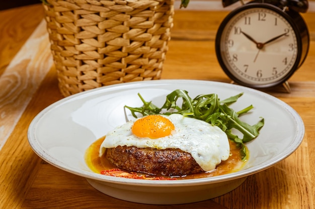 Breakfast fried eggs with beefsteak arugula and sundried tomato