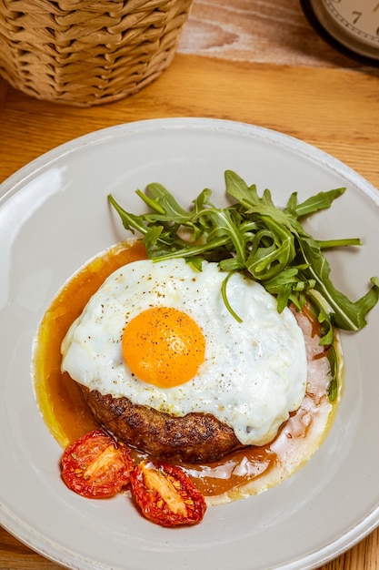 Breakfast fried eggs with beefsteak arugula and sundried tomato