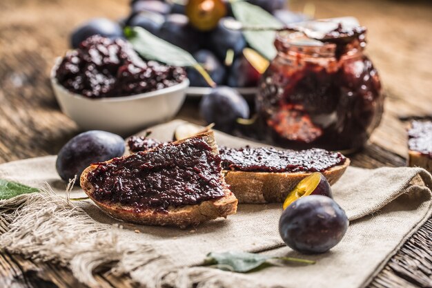 Photo breakfast from homemade plum jam bread and fresh ripe plums.