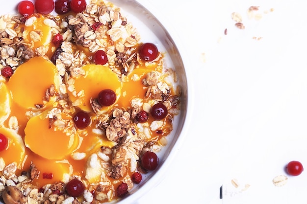 Breakfast granola with cranberries banana and mango mousse