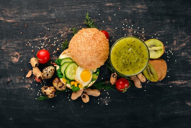 Breakfast Kiwi and burger cheese with quail eggs and vegetables On a wooden background Top view Copy space