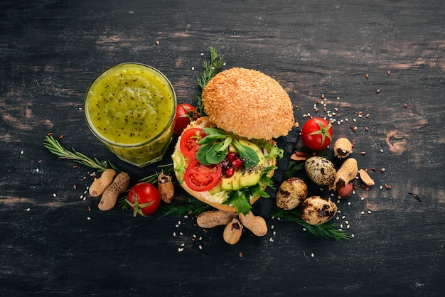 Breakfast Kiwi and burger cheese with quail eggs and vegetables On a wooden background Top view Copy space