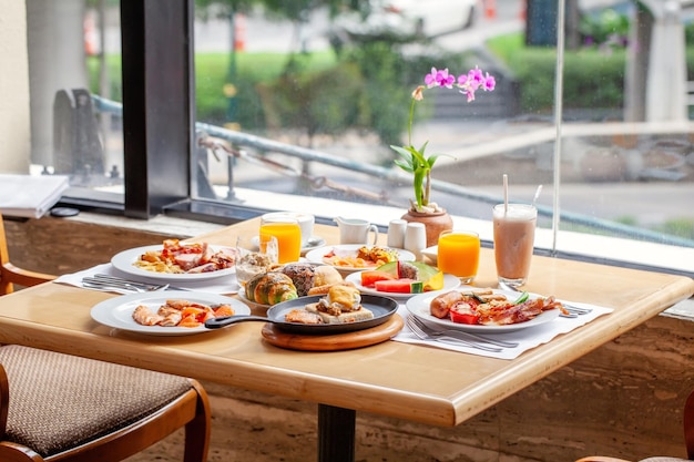 Breakfast in luxury hotel table full various food from buffet in modern resort