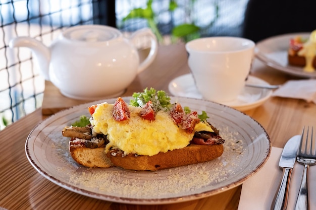 Breakfast sandwich with toasted bread ham scrambled mushrooms egg