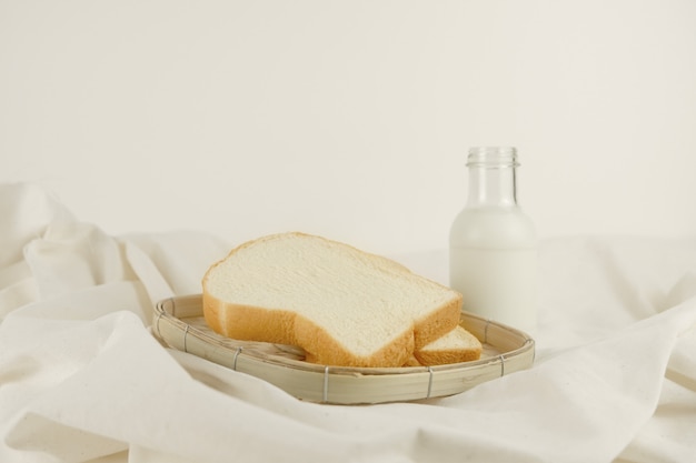 Breakfast set fresh milk and bread on canvas background