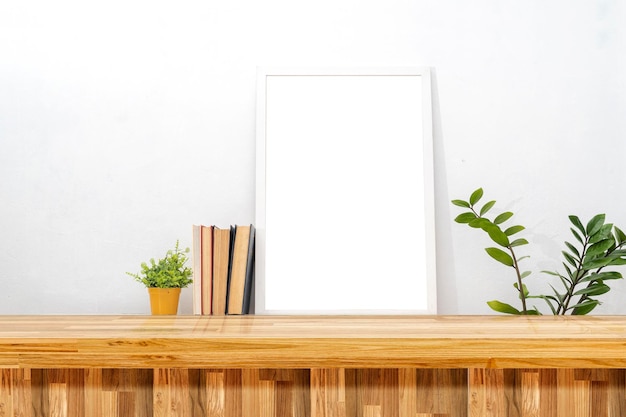 Breakfast still life Cup of coffee books and empty picture frame mockup on table