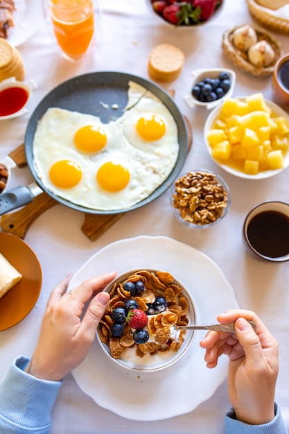 Breakfast on the table top viewFood on the table top viewMuesli with berries Fried eggsMeal day