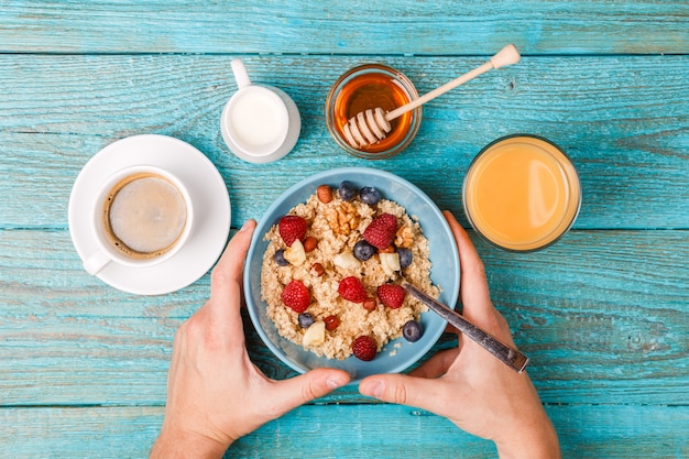 Breakfast table with waffles, oatmeal, cereals, coffee, juice and fresh berries