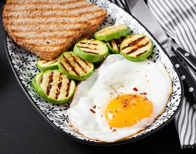 Breakfast Toast with avocado guacamole grilled zucchini and fried egg Brunch