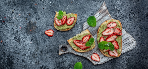 Breakfast toast with guacamole, strawberries and chia seeds