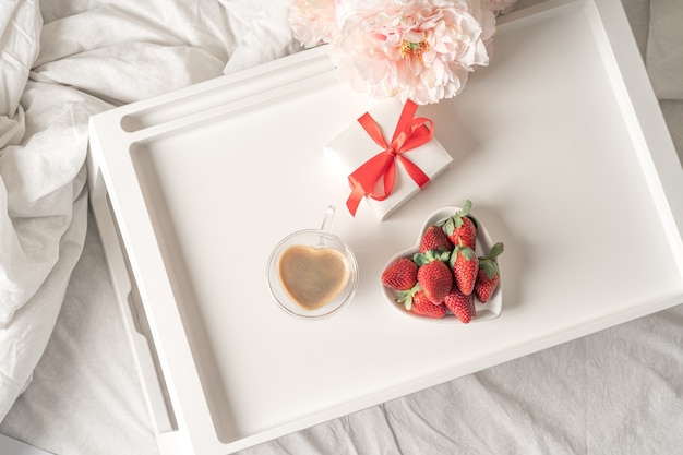 Breakfast for Valentine's Day with coffee and strawberries.