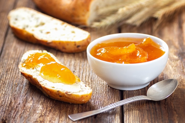 Breakfast with apricot jam and slice of bread