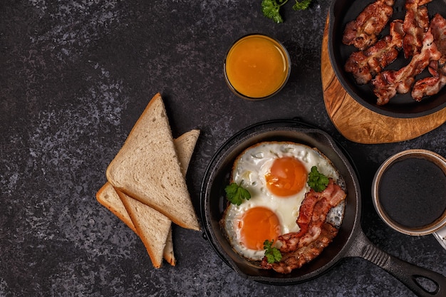 Breakfast with bacon , fried egg, coffee and orange juice