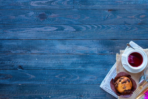 Breakfast with coffee and tea with different pastries and fruits on a wooden table