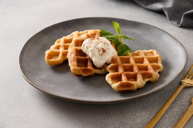 Breakfast with croffles on gray background Croissant as waffle