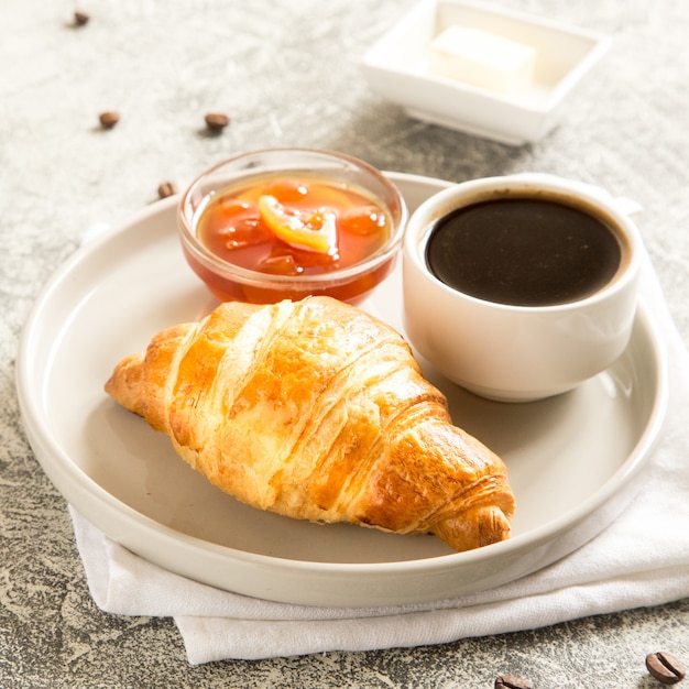 Breakfast with croissants on concrete