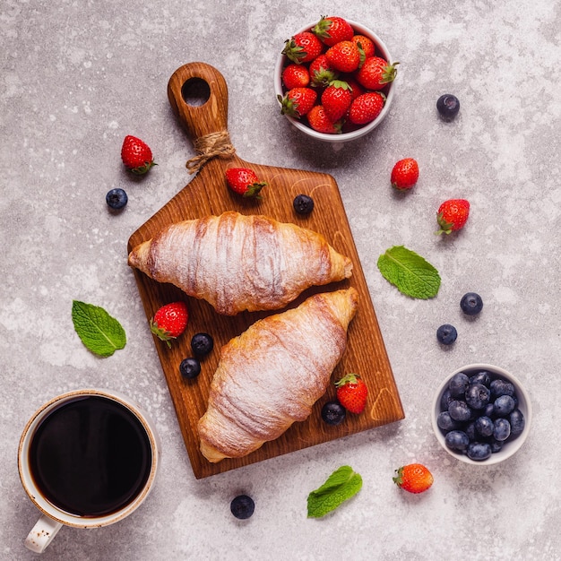 Breakfast with croissants and fresh fruits