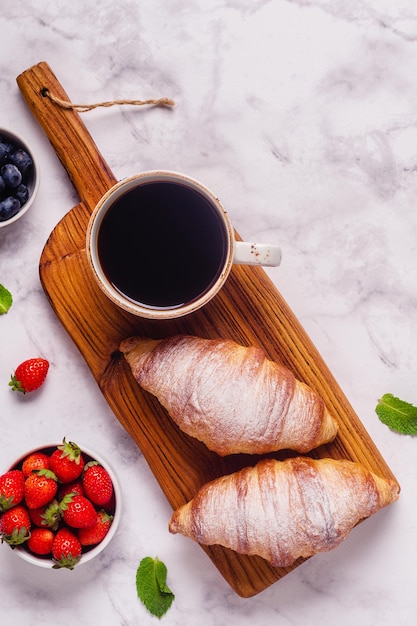 Breakfast with croissants and fresh fruits