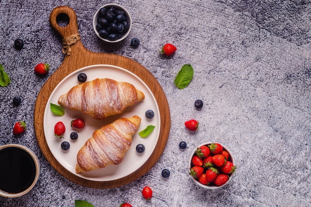 Breakfast with croissants and fresh fruits