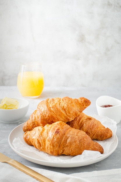 Breakfast with croissants and orange juice.
