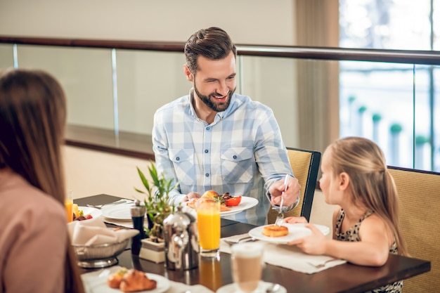 Breakfast with daughter. Young father having a breakfast with his daughter