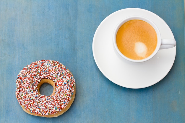 Breakfast with fresh coffee and one donut