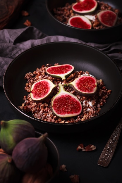 Breakfast with granola and figs. Black plates with a fresh and healthy Breakfast. Healthy food