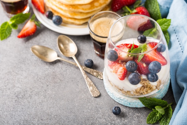 Breakfast with granola, pancakes and berries