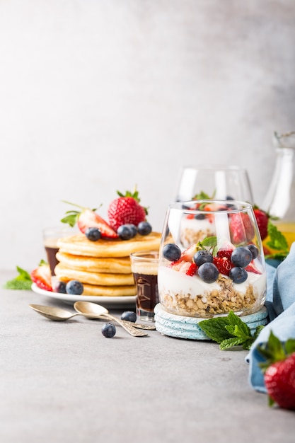 Breakfast with granola, pancakes and berries