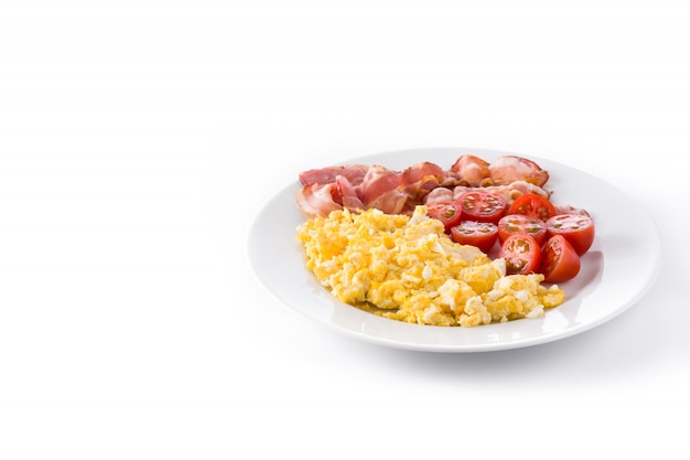 Breakfast with scrambled eggs, bacon and tomatoes isolated copy space