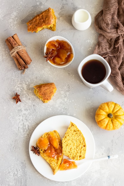 Breakfast with spicy pumpkin scones, a cup of tea and milk.