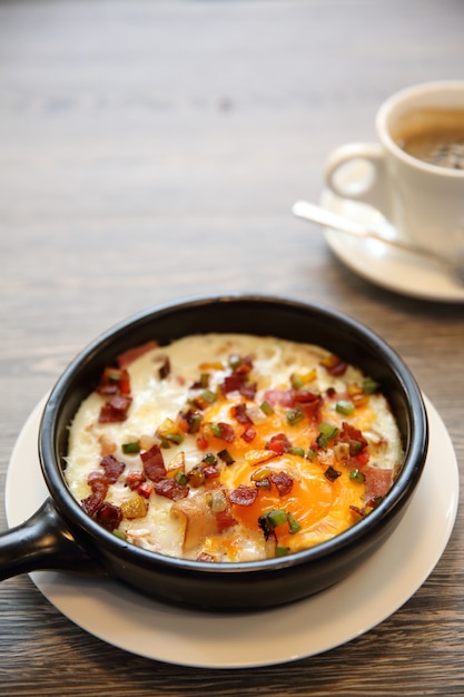 Brealfast fried egg stuff with hot pan with coffee