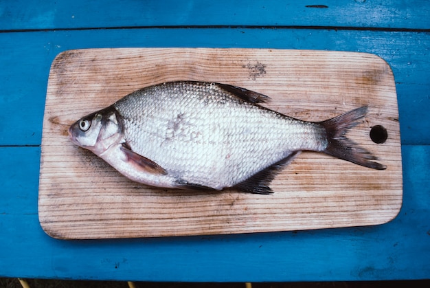 Photo bream fish on a cutting board.