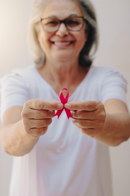 Breast Cancer Awareness Month image Mature White Woman With pink ribbon isolated