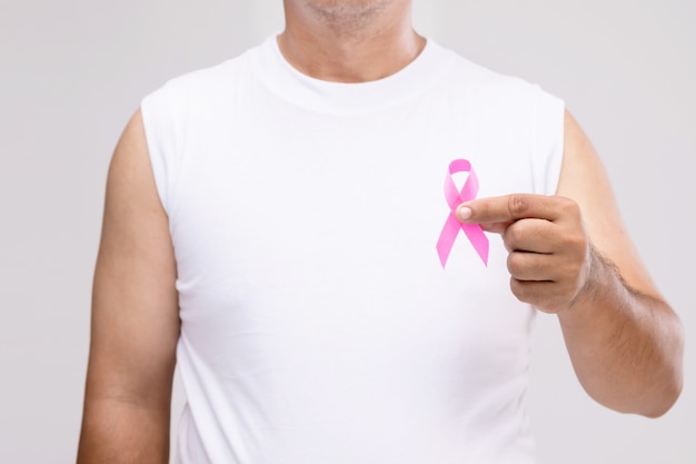 Breast cancer in men concept : Portrait Asian man and pink ribbon the symbol of breast cancer campaign. 