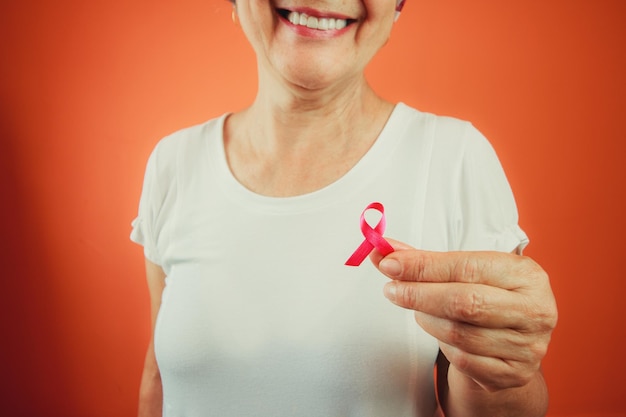 Breast Cancer Protection Symbol Mature Woman With Pink Ribbon on and White t shirt isolated for breast cancer campaign