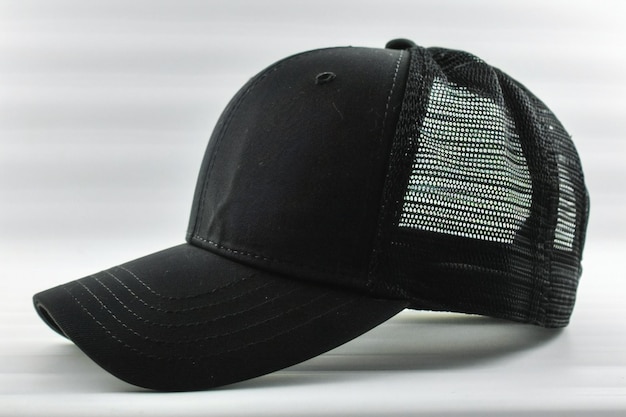 Photo breathtaking featuring black trucker hat mockup on white background side view the cap is solid bla