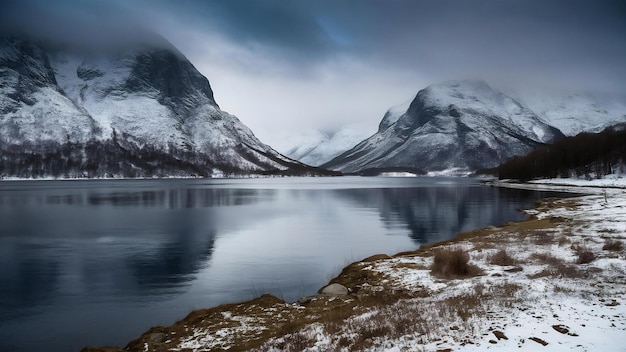 Breathtaking shot of a lake surrounded by the snowy mountains under the foggy sky in norway